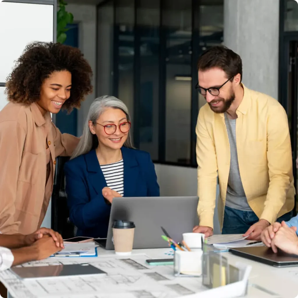 A team of professionals focused on a laptop