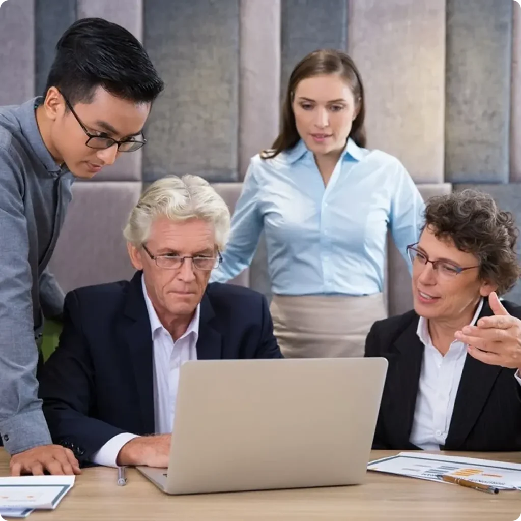 Business professionals collaborating on a laptop