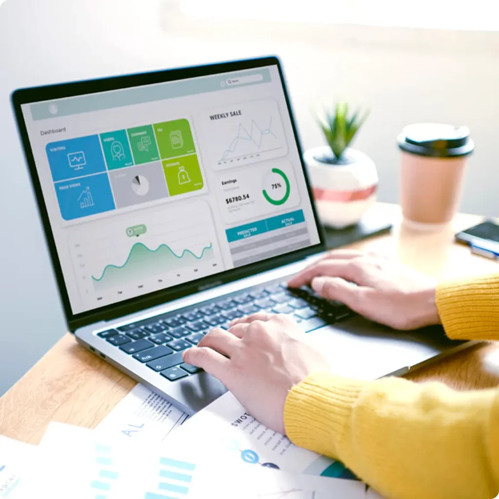 A user interacts with a laptop that shows a graph