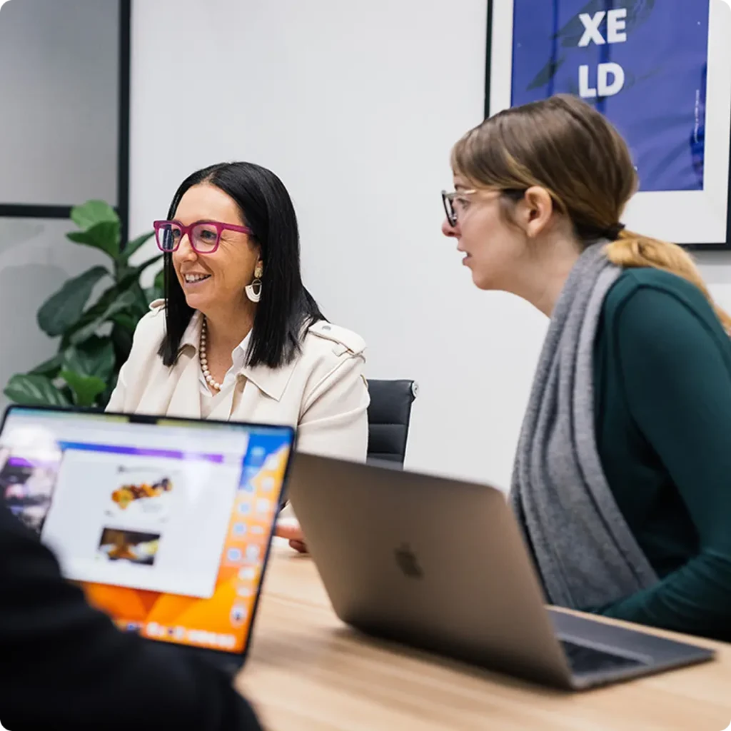 Three women gathered around a table